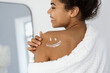 © brizmaker - Happy afro american woman with a cream painted smile on shoulder