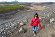 Smiling Woman Hiker Climbing A Steep Path On The Side Of A Volcano In Iceland