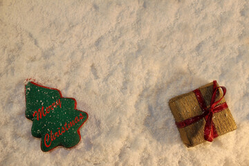 Wall Mural - beautiful green Christmas tree and a gift lies on the white snow