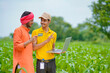 © PRASANNAPIX - Young indian banker or agronomist showing some detail to farmers in laptop at agriculture field.
