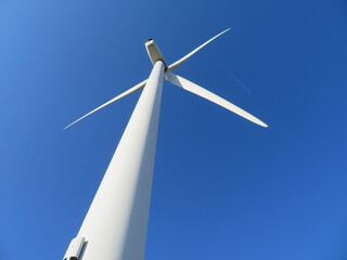 Poster - Low angle view of white wind turbine with a beautiful sky backgro