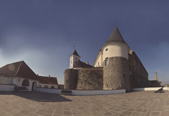  panoramic view of the top tower of a stone castle from the courtyard