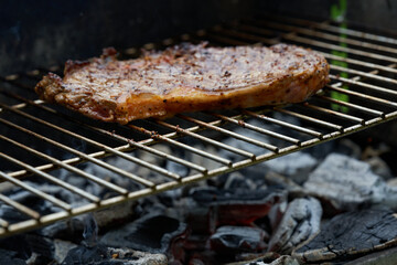 Wall Mural - Closeup shot of a grilling steak on a blurred background