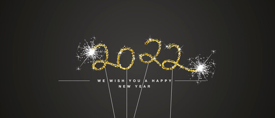 We wish you Happy New Year 2022 eve handwritten tipography golden glitter stars sparkler fireworks black background greeting card