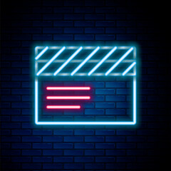 Sticker - Glowing neon line Movie clapper icon isolated on brick wall background. Film clapper board. Clapperboard sign. Cinema production or media industry. Colorful outline concept. Vector