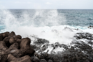 Rocky coast and splashing ocean waves.