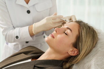 Sticker - Woman during facial filler injections in aesthetic medical clinic