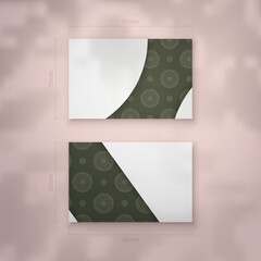 Business card template in dark green color with Indian white ornaments for your business.