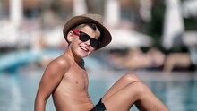 Laughing Boy In Straw Hat Sunglasses Waving Hand Posing Swimming Pool Resting Luxury Hotel Resort