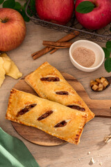 Wall Mural - Baked apple hand pie in wooden background