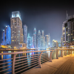 Wall Mural - Night time panoramic view of Dubai Marina bay and city center, UAE