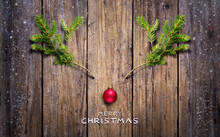 Christmas Concept - Reindeer Made With Fir Branches And Red Ball On Wooden Plank
