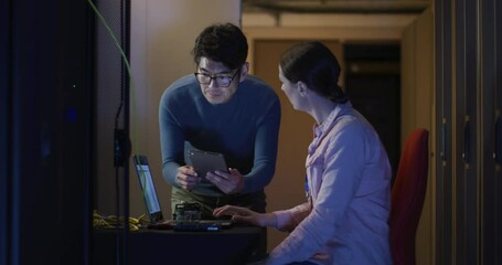 Wall Mural - diverse female and male it technicians using laptop checking computer server