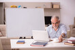 © Elnur - Old male employee working from home during pandemic