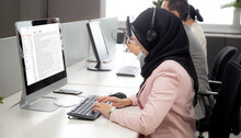 Young Businesswoman Is Muslim Or Islam And Team Wearing  Headphone With Diversity Ethnicity While Call Center Support Customer Service And Check Email On Computer At The Office, Business Concept.