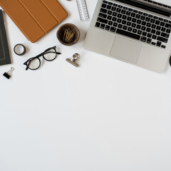Wall Mural - Aesthetic minimalist home office desk workspace on white background with blank copy space. Notes sheet, laptop computer, tablet pad, stationery. Business, work concept for blog, website, social media