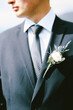 © Nadtochiy - Groom in a black jacket, white shirt, polka-dot tie with a boutonniere. Close up