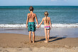 © Nataliia Makarovska - two happy children holding hands looking at the sea, horizontal