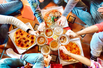 Wall Mural - Top view of friends roomates eating take away pizza at shared apartment - Friendship concept with people students enjoying time together and having fun at afternoon chilling - Focus on pint glasses