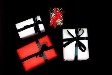 Wall Mural - Gifts wrapped with colorful paper on black background