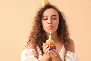 Wall Mural - Beautiful African-American woman with Birthday cake on color background