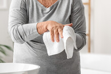 Elderly Woman Washing Hands In Bathroom