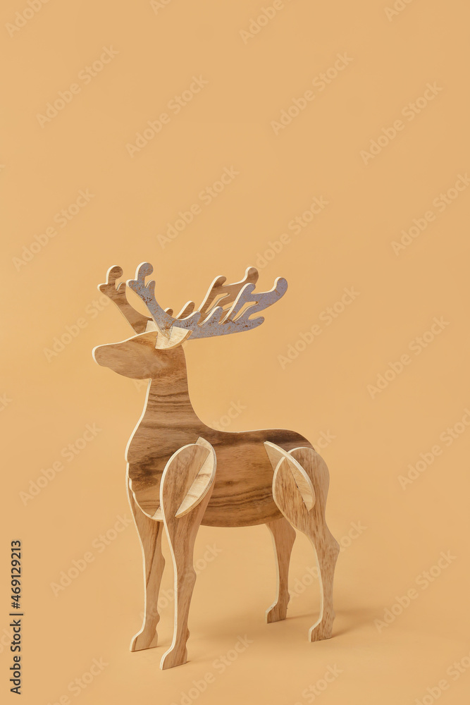 Wooden reindeer on beige background