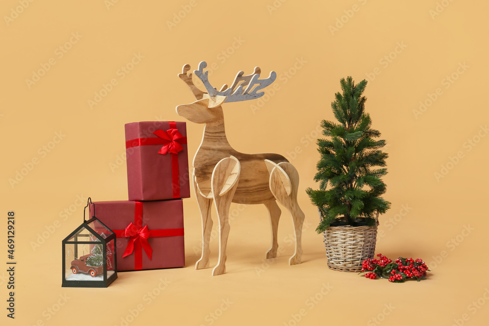 Wooden reindeer with Christmas tree and presents on beige background