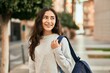 © Krakenimages.com - Young middle east student girl smiling happy standing at the city.