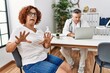 © Krakenimages.com - Senior woman sitting at doctor appointment afraid and terrified with fear expression stop gesture with hands, shouting in shock. panic concept.