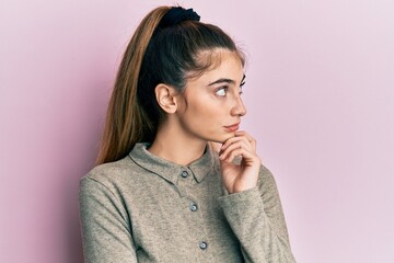 Poster - Young caucasian woman wearing casual clothes thinking concentrated about doubt with finger on chin and looking up wondering