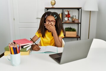 Poster - Young african american girl doing homework at home bored yawning tired covering mouth with hand. restless and sleepiness.