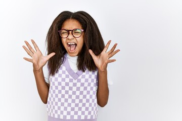 Poster - Young african american girl standing over isolated background celebrating mad and crazy for success with arms raised and closed eyes screaming excited. winner concept