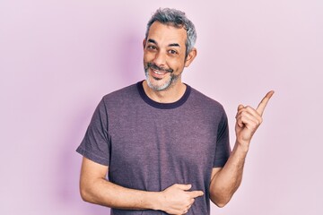 Sticker - Handsome middle age man with grey hair wearing casual t shirt smiling happy pointing with hand and finger to the side