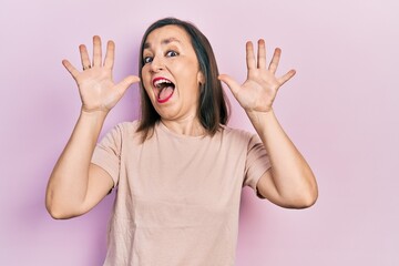 Poster - Middle age hispanic woman wearing casual clothes showing and pointing up with fingers number ten while smiling confident and happy.