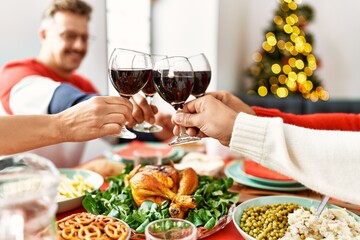 Sticker - Group of middle age people smiling happy having christmas dinner toasting with wine at home.