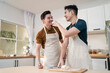 © Kawee - Asian young LGBTQ male gay family enjoy bake bakery in kitchen at home.