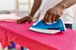 © Krakenimages.com - Young african american man smiling confident ironing at laundry
