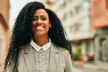 Sticker - Middle age african american businesswoman smiling happy standing at the city.