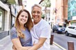 © Krakenimages.com - Middle age hispanic couple of husband and wife together on a sunny day outdoors. Smiling happy in love hugging at the city