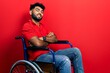Arab man with beard sitting on wheelchair happy face smiling with crossed arms looking at the camera. positive person.