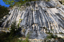Tall Limestone Rock Climbing Wall With Overhanging Featured Black And Orange Tufa Pipes In Alto Area In Nothern Italy