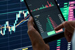 © insta_photos - Crypto trader investor broker holding finger on buy or sell button executing financial stock trade market trading order thinking of cryptocurrency or shares assets investment risks and profit concept.