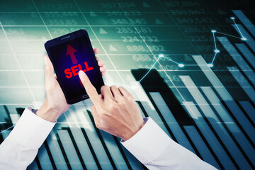 Businessman selling stock exchange on mobile phone