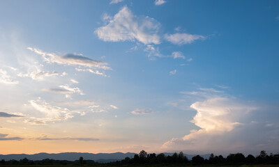 Wall Mural - Colorful sunset and sunrise with clouds.Blue and orange color of nature.Many white clouds in the blue sky.The weather is clear today.sunset in the clouds.The sky is twilight.