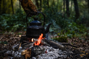 Wall Mural - Vintage black pot on Firewood burning. kettle on fire