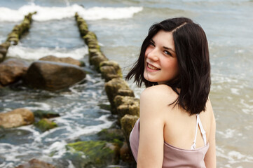 Wall Mural - portrait of a young beautiful woman by the sea