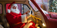 Portrait Of Santa Claus Driving A Red Car For Christmas.