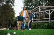 © Halfpoint - Happy young family playing games during picnic outdoors in restaurant area.