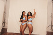 © Jacob Lund - Cheerful young women dancing while wearing blue underwear